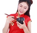 Woman wearing chinese cheongsam dress with chopsticks and bowl i Royalty Free Stock Photo