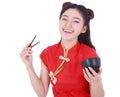 Woman wearing chinese cheongsam dress with chopsticks and bowl i Royalty Free Stock Photo