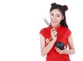 Woman wearing chinese cheongsam dress with chopsticks and bowl i Royalty Free Stock Photo