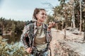 Happy woman wearing short denim shorts feeling happy hiking with backpack Royalty Free Stock Photo