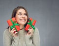 Happy woman wearing sweater holding two red gift boxes. Royalty Free Stock Photo