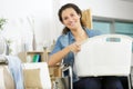 happy woman in wheelchair holding basket