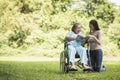 Happy Woman in a wheelchair reading a book with her daughter Royalty Free Stock Photo