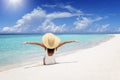 A happy woman in a white bathing suit sits on a tropical beach Royalty Free Stock Photo