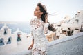 Woman in white dress and straw hat on Santorini island Royalty Free Stock Photo