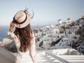 Woman in white dress and straw hat on Santorini island Royalty Free Stock Photo