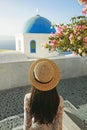 Woman in white dress and straw hat on Santorini island Royalty Free Stock Photo