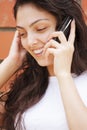 Happy woman in white talking cellphone Royalty Free Stock Photo