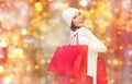 Happy woman in winter clothes with shopping bags Royalty Free Stock Photo