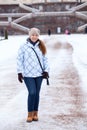 Happy woman in winter clothes standing in front of the Palace staircase Royalty Free Stock Photo