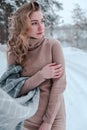 Happy woman on the winter forest background. Young pretty girl in the woods outdoors. Portrait of a cheerful beautiful Royalty Free Stock Photo