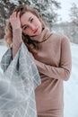 Happy woman on the winter forest background. Young pretty girl in the woods outdoors. Portrait of a cheerful beautiful Royalty Free Stock Photo