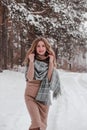 Happy woman on the winter forest background. Young pretty girl in the woods outdoors. Portrait of a cheerful beautiful Royalty Free Stock Photo