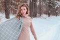 Happy woman on the winter forest background. Young pretty girl in the woods outdoors. Portrait of a cheerful beautiful Royalty Free Stock Photo