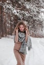 Happy woman on the winter forest background. Young pretty girl in the woods outdoors. Portrait of a cheerful beautiful Royalty Free Stock Photo