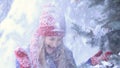 Happy woman in winter forest getting snow shower