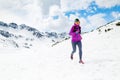 Happy woman winter trail running in beautiful inspirational land