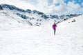 Happy woman winter trail running in beautiful inspirational land