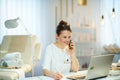 Happy woman worker in beauty salon talking on phone Royalty Free Stock Photo