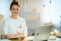 Happy woman worker with clipboard in modern beauty salon Royalty Free Stock Photo