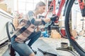 Happy woman working as a bicycle mechanic Royalty Free Stock Photo