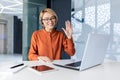 Happy woman working inside office, businesswoman with video call headset talking and advising customers remotely, tech Royalty Free Stock Photo