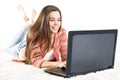 Happy Woman working on Laptop. Young Girl typing on Computer Keyboard. Woman looking at Screen and write over White Background Royalty Free Stock Photo