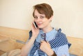 Happy woman works with mobile phone at home. Smiling young female working in cozy remote work, E learning concept Royalty Free Stock Photo