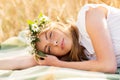 Happy woman in wreath of flowers on cereal field Royalty Free Stock Photo