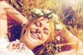 Happy woman in wreath of flowers lying on straw Royalty Free Stock Photo