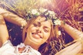 Happy woman in wreath of flowers lying on straw Royalty Free Stock Photo