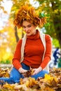 Happy woman with a wreath of maple leaves on her head Royalty Free Stock Photo