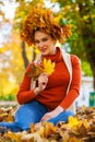 Happy woman with a wreath of maple leaves on her head Royalty Free Stock Photo