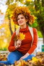 Happy woman with a wreath of maple leaves on her head Royalty Free Stock Photo