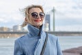 Happy woman 40-45 years old with glasses on a blurry urban landscape background, natural smile, natural teeth,close-up, Royalty Free Stock Photo