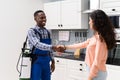 Woman And Pest Control Worker Shaking Hands Royalty Free Stock Photo