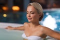 Happy womani sitting in jacuzzi at poolside Royalty Free Stock Photo