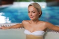 Happy womani sitting in jacuzzi at poolside Royalty Free Stock Photo