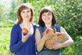 Happy women with apples in orchard Royalty Free Stock Photo