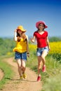Happy women on blooming field in summer Royalty Free Stock Photo