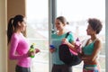 Happy women with bottles of water in gym Royalty Free Stock Photo