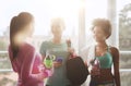 Happy women with bottles of water in gym Royalty Free Stock Photo