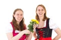 Happy women in dirndl with bunch of roses