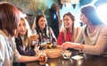 Happy women drinking beer at brewery restaurant - Female friendship concept with young girlfriends enjoying time together