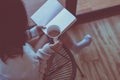 Happy woman drinking coffee and reading book at home in the morning,Relax time,Close up Royalty Free Stock Photo