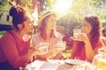 Happy women with drinks at summer garden party Royalty Free Stock Photo