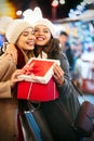 Happy women friends exchanging christmas present. Happiness people friend shopping xmas concept