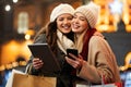 Happy women friends shopping Christmas gifts in the city. People holiday sale happiness concept Royalty Free Stock Photo