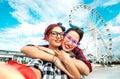 Happy women girlfriends taking selfie at ferris wheel on public area - Friendship and travel concept with pin-up styled girls Royalty Free Stock Photo