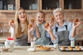 Happy women holding freshly baked cupcakes and smiling Royalty Free Stock Photo